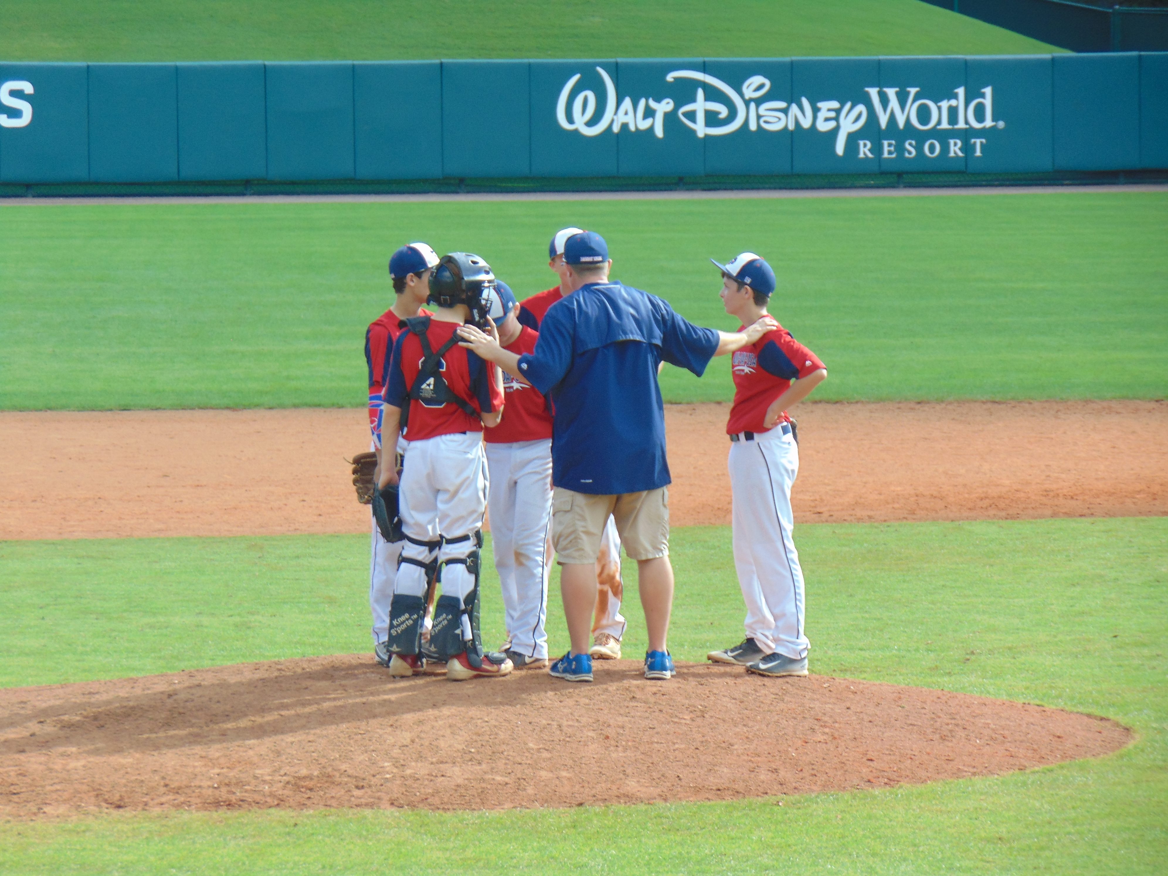 Jason Taulman coaches his pitcher on the mound at Walt Disney World Resort